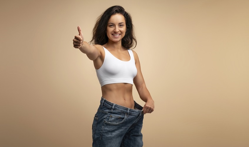 Young woman happy after losing weight
