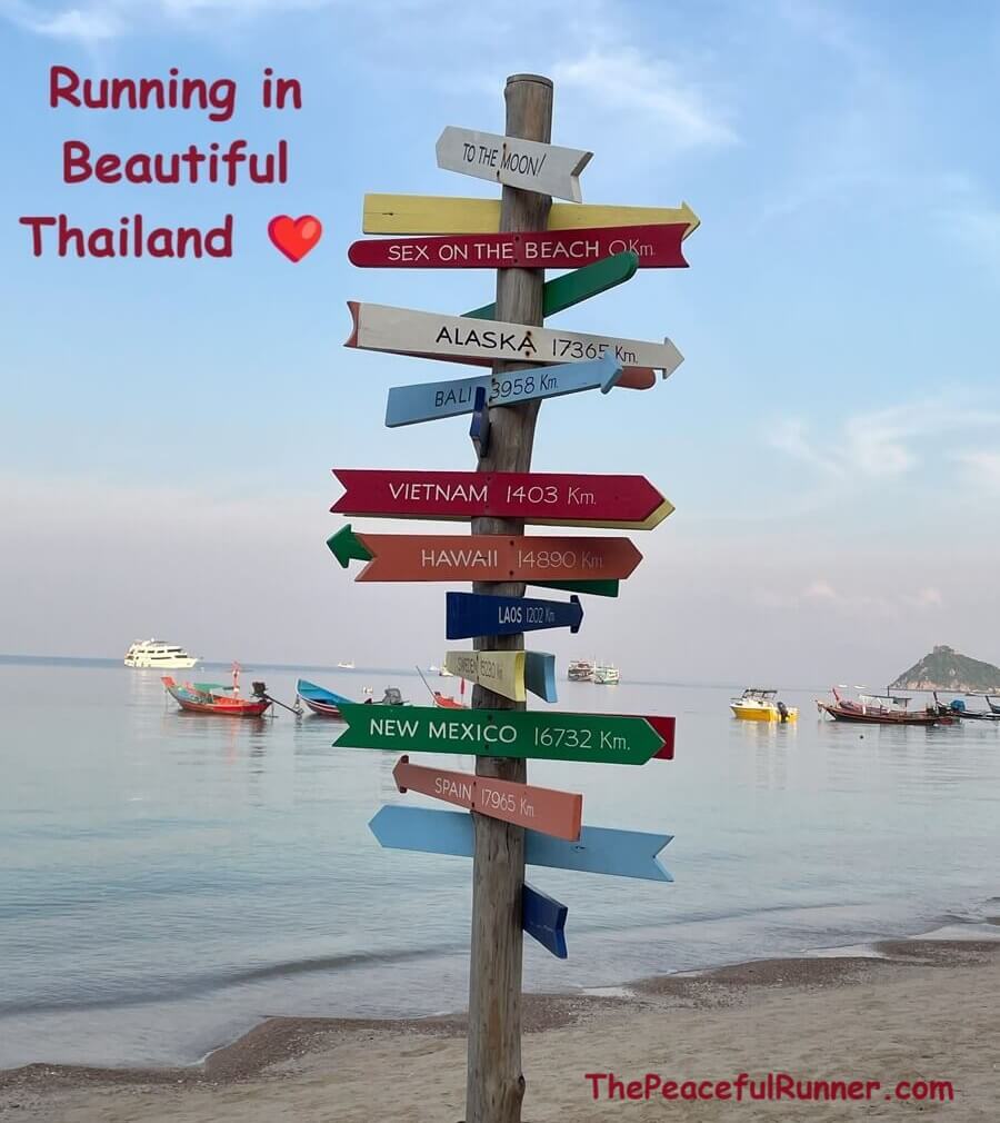 Sandy beach in Thailand with colourful signposts