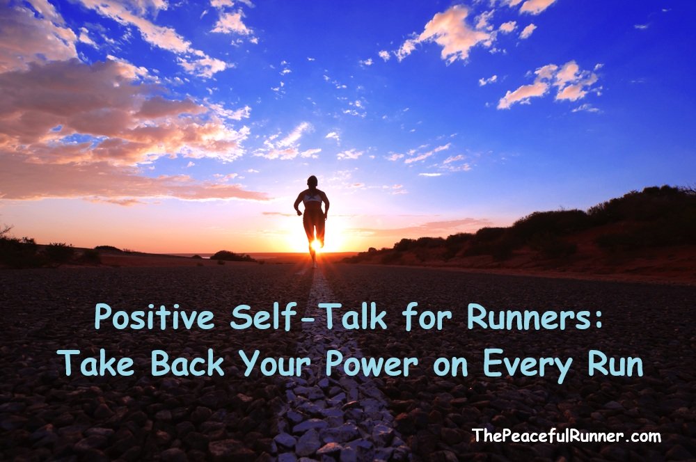 Male athlete on top of mountain with hand in the air